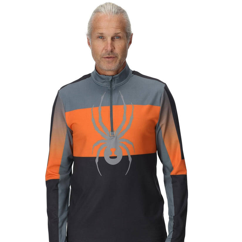 Man wearing a sports jacket with a spider logo on a white background
