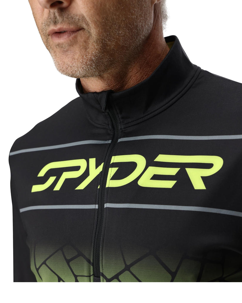 Close-up of a person wearing a black Spyder cycling jacket with green logo.