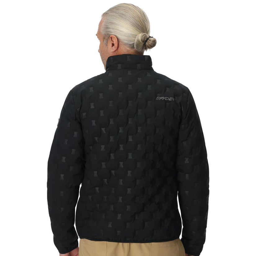 Person wearing a black jacket with a pattern on the back, standing against a white background