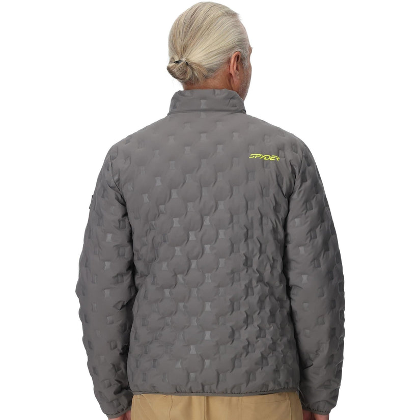 Person wearing a gray quilted jacket with a brand logo on the back, standing against a white background.
