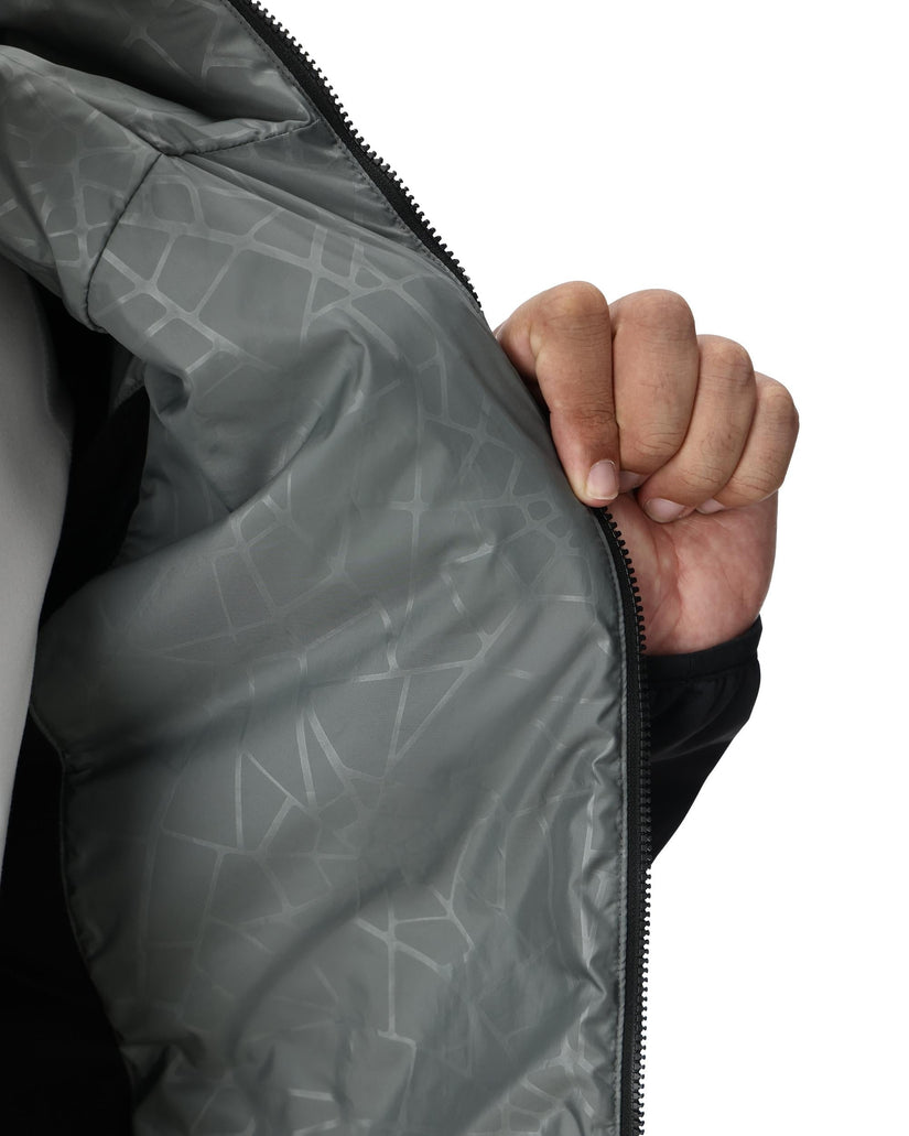 Hand zipping a gray jacket with geometric pattern on a white background