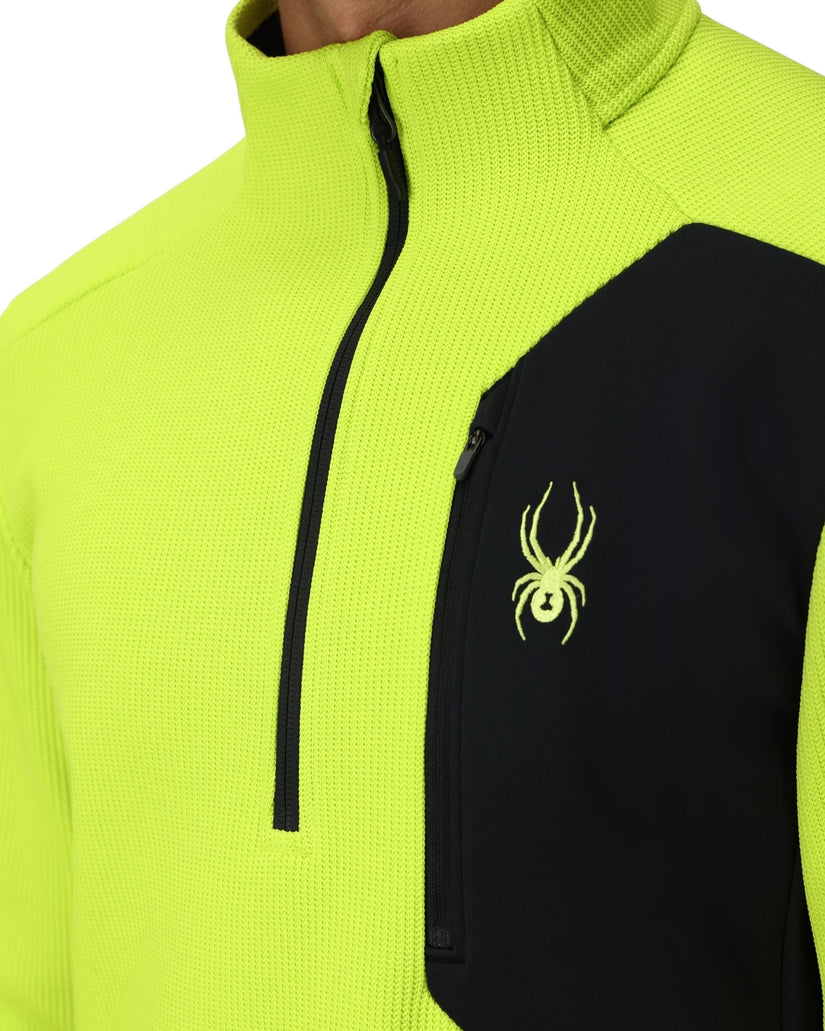 Neon green and black jacket with a spider logo on a white background