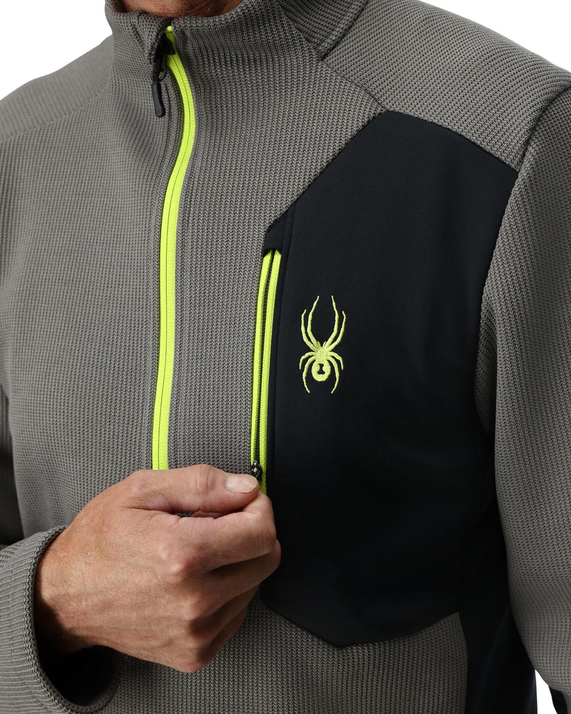 Gray and black jacket with a green zipper and logo on a white background