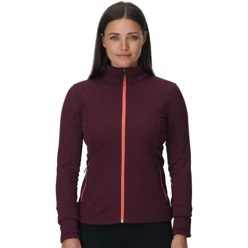 Woman wearing a maroon jacket with a red zipper on a white background