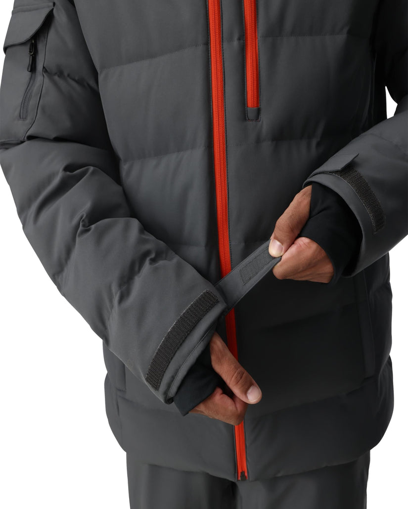 Person wearing a dark gray winter jacket with a red zipper on a white background