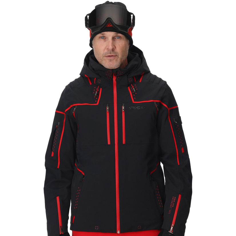 Person wearing a black and red ski jacket with goggles on a white background