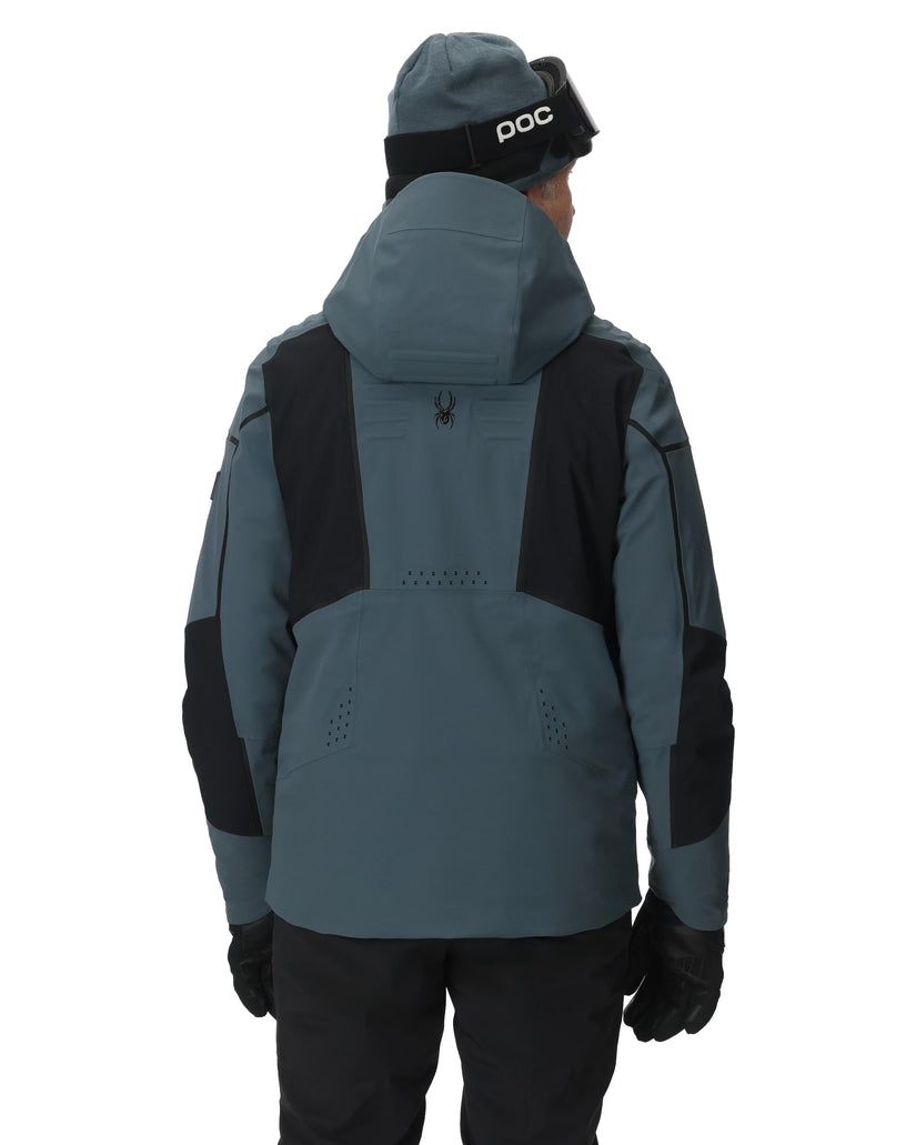 Person wearing a gray and black jacket with a hood on a white background
