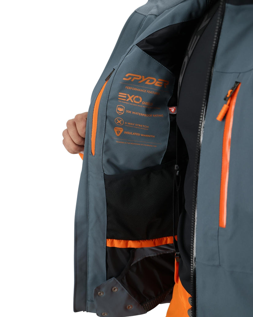 Gray and orange Spyder jacket with visible branding on a white background