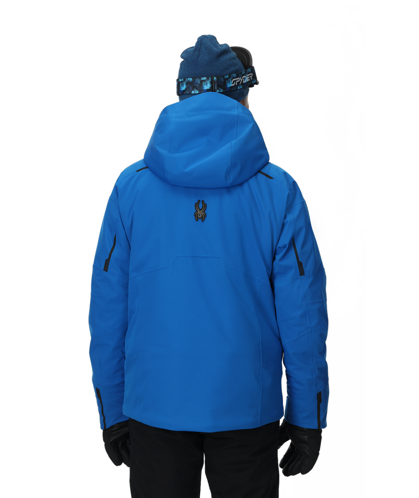 Person wearing a blue jacket and hat on a white background