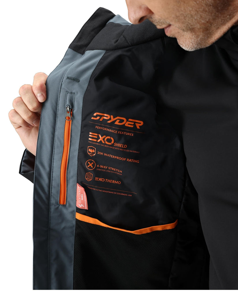 Person wearing a black and gray jacket with Spyder branding