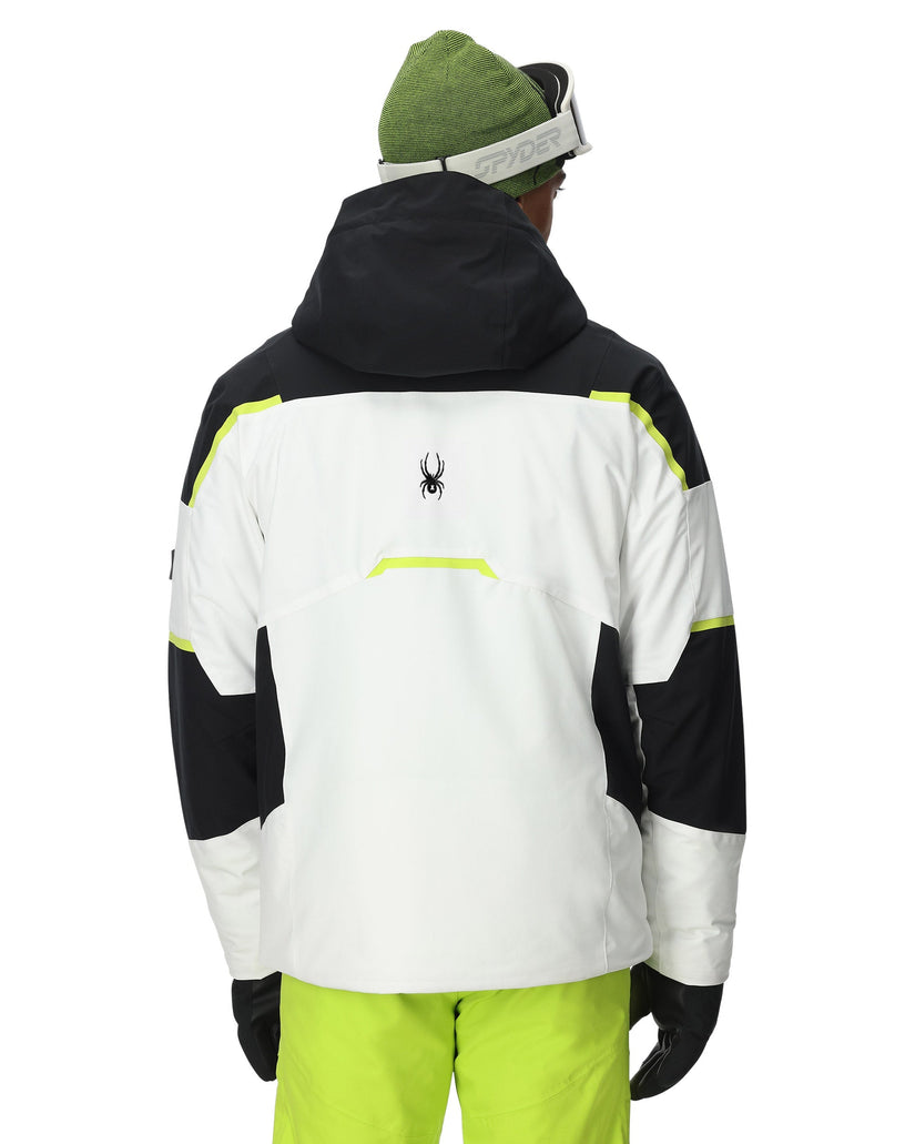 Person wearing a black, white, and green jacket with a visible brand logo on a white background