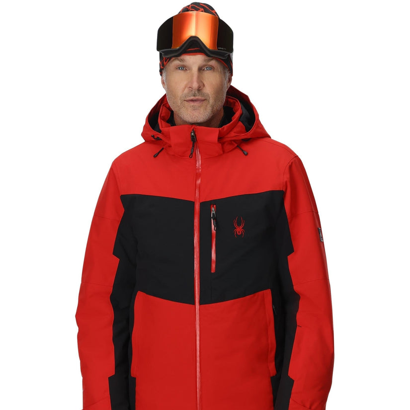 Person wearing a red and black jacket with a brand logo on a white background