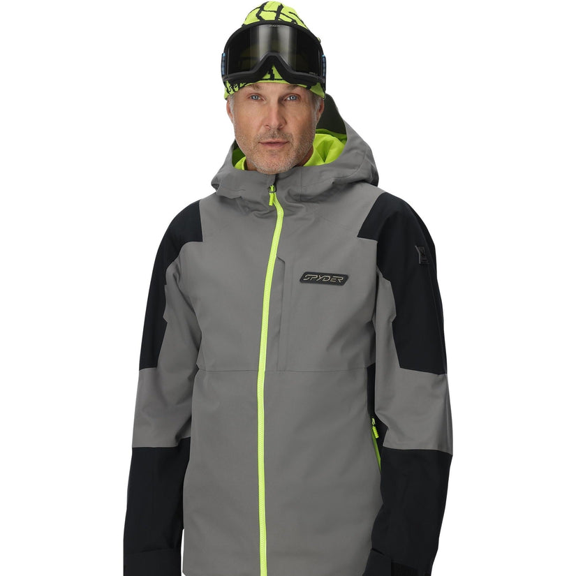 Person wearing a gray and black jacket with neon green accents on a white background
