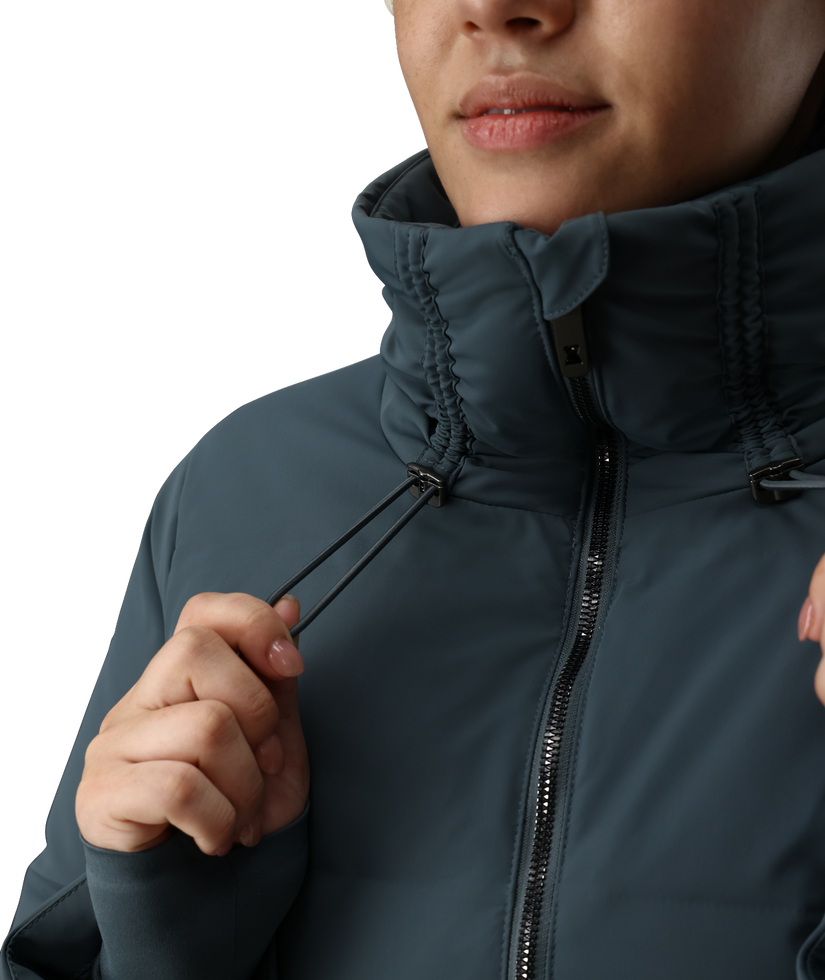 Person wearing a dark blue jacket with a high collar on a white background