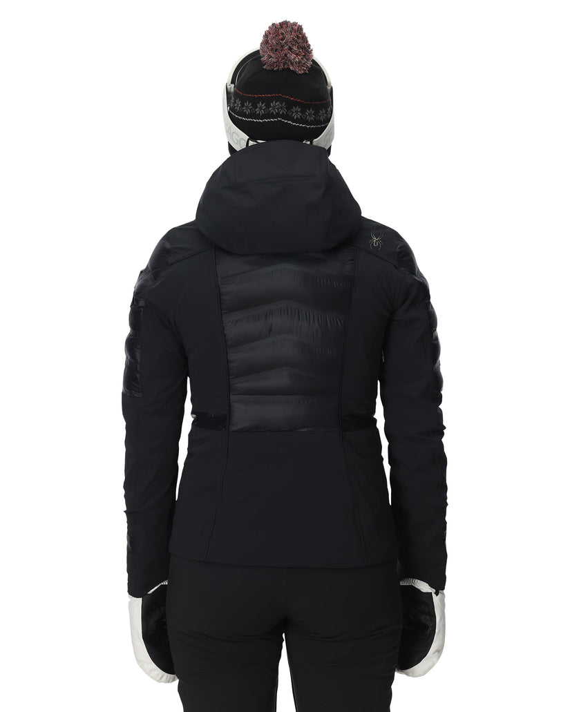 Person wearing a black winter coat with a hood on a white background