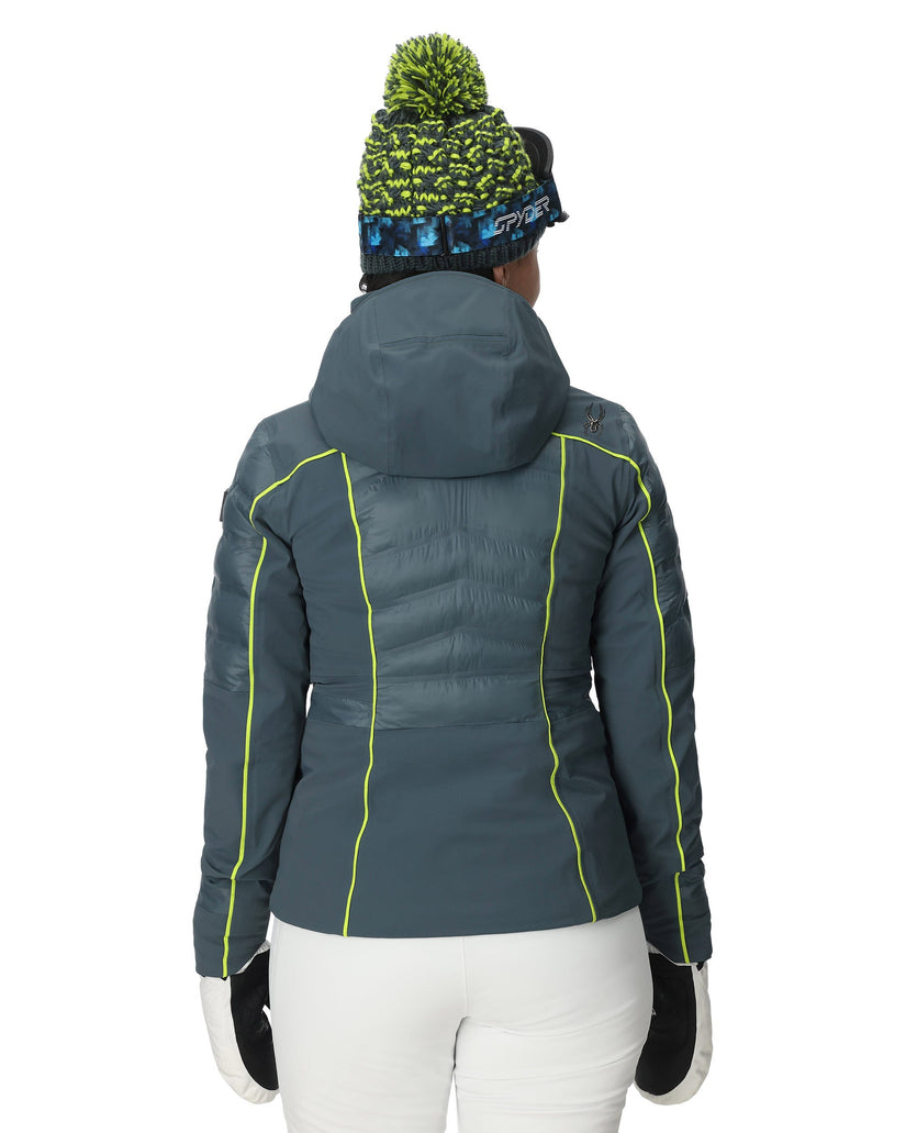 Person wearing a gray jacket with green accents on a white background