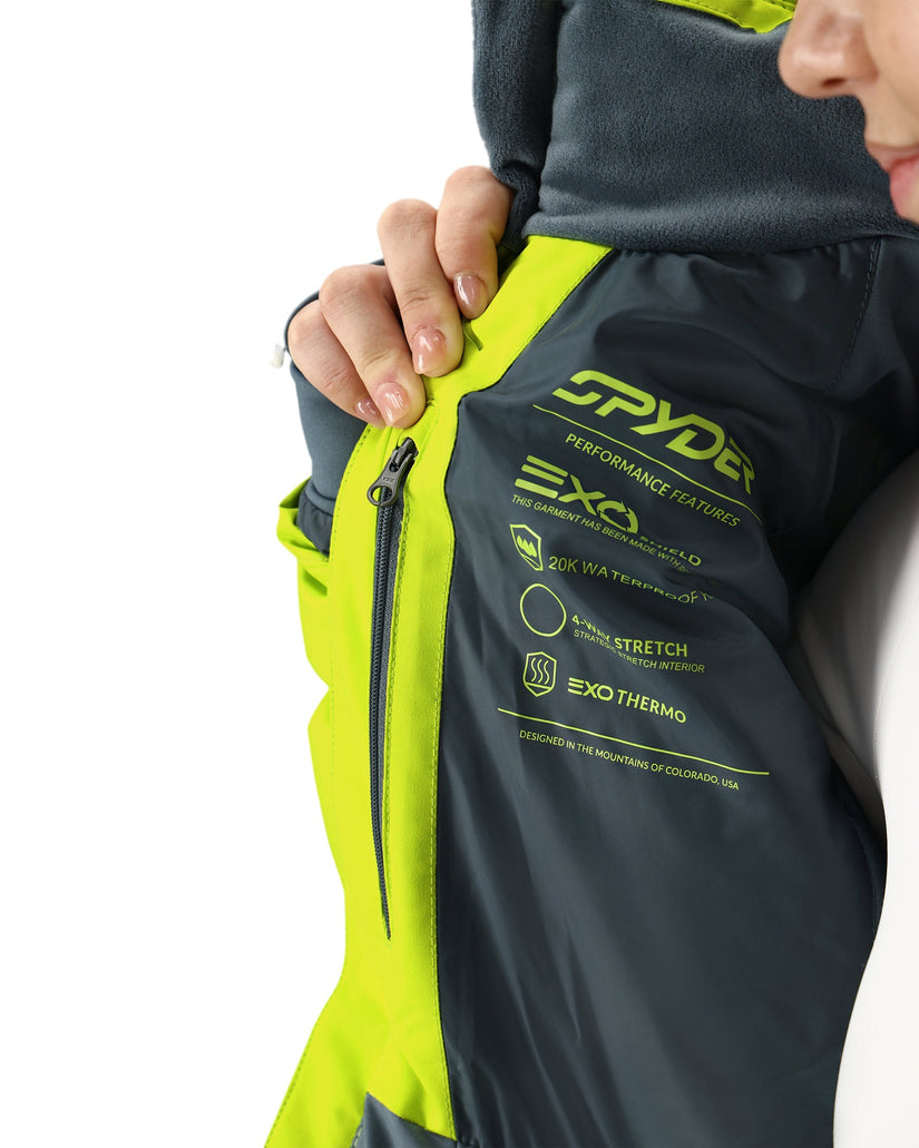 Close-up of a person wearing a Spyder jacket with visible branding and product features.