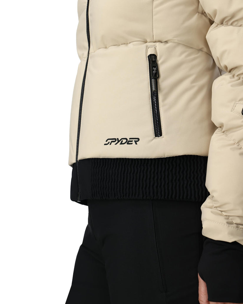 Close-up of a beige puffer jacket with a Spyder logo on a white background