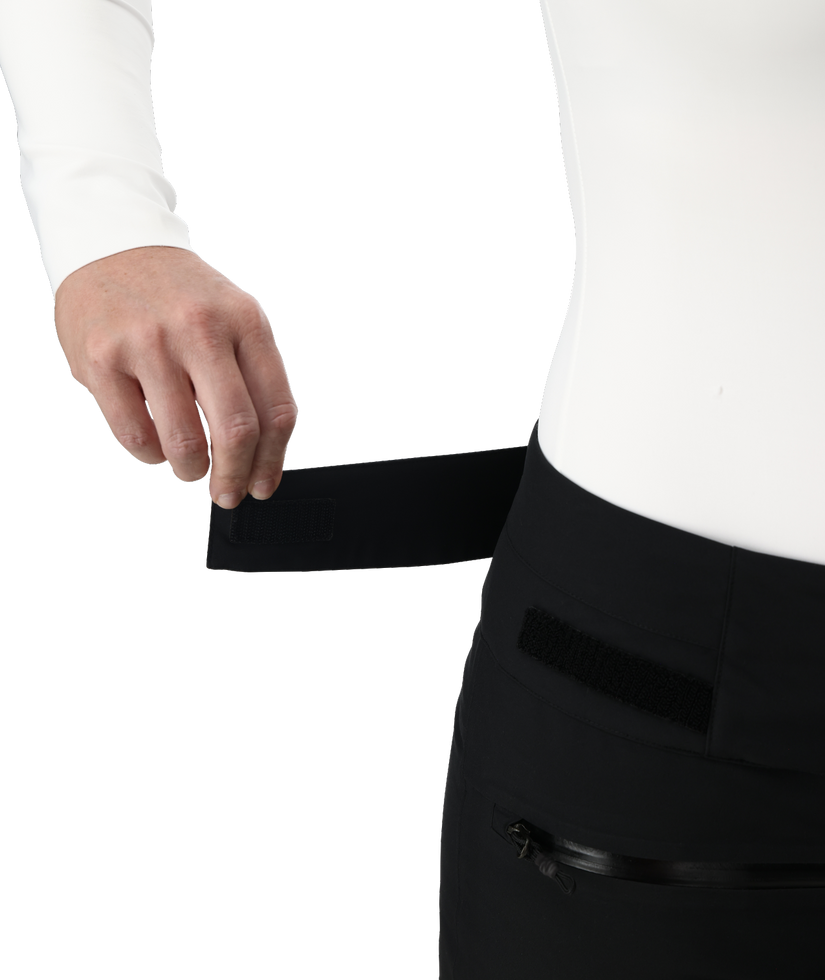 Person wearing a white shirt and black pants with a white background
