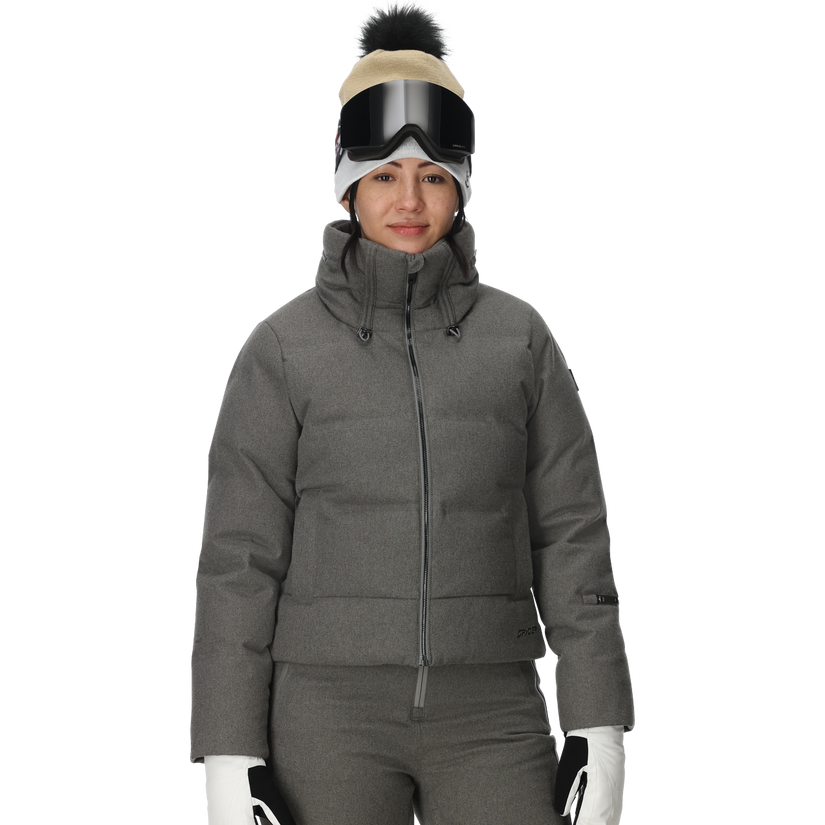 Person wearing a gray winter jacket, pants, gloves, and a beanie with goggles on a white background