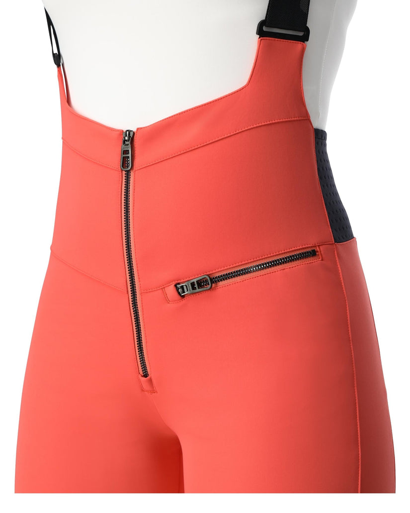 Coral pink bib overalls with black zippers on a white background