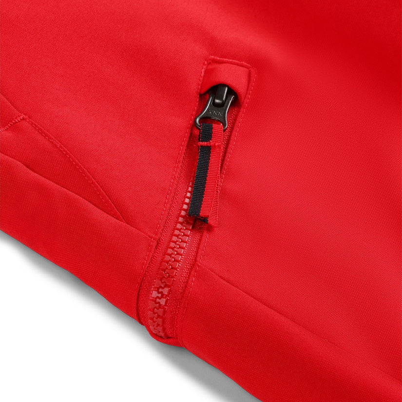 Red ski pants with adjustable suspenders and zippered hand pockets.